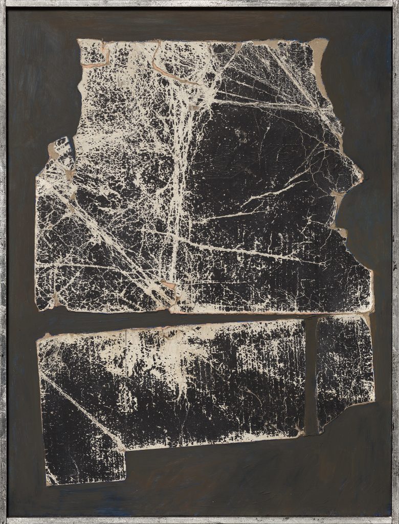 Part of a found, creased black and white cardboard box on a painted wood panel